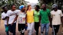 Carole walking arm in arm with members of Light of the World drama troupe, Rwanda