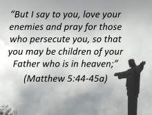 Statue of Jesus with arms outstretched with verse, "Love your enemies..."